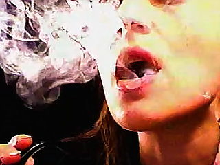 Get a load of this fetish video in which this brunette MILF is smoking a cigar and playing with the smoke.